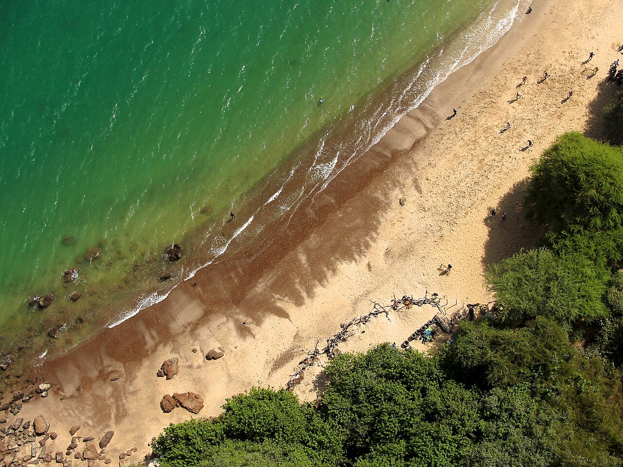 A beach in Dakar from above, green sea meeting sand.