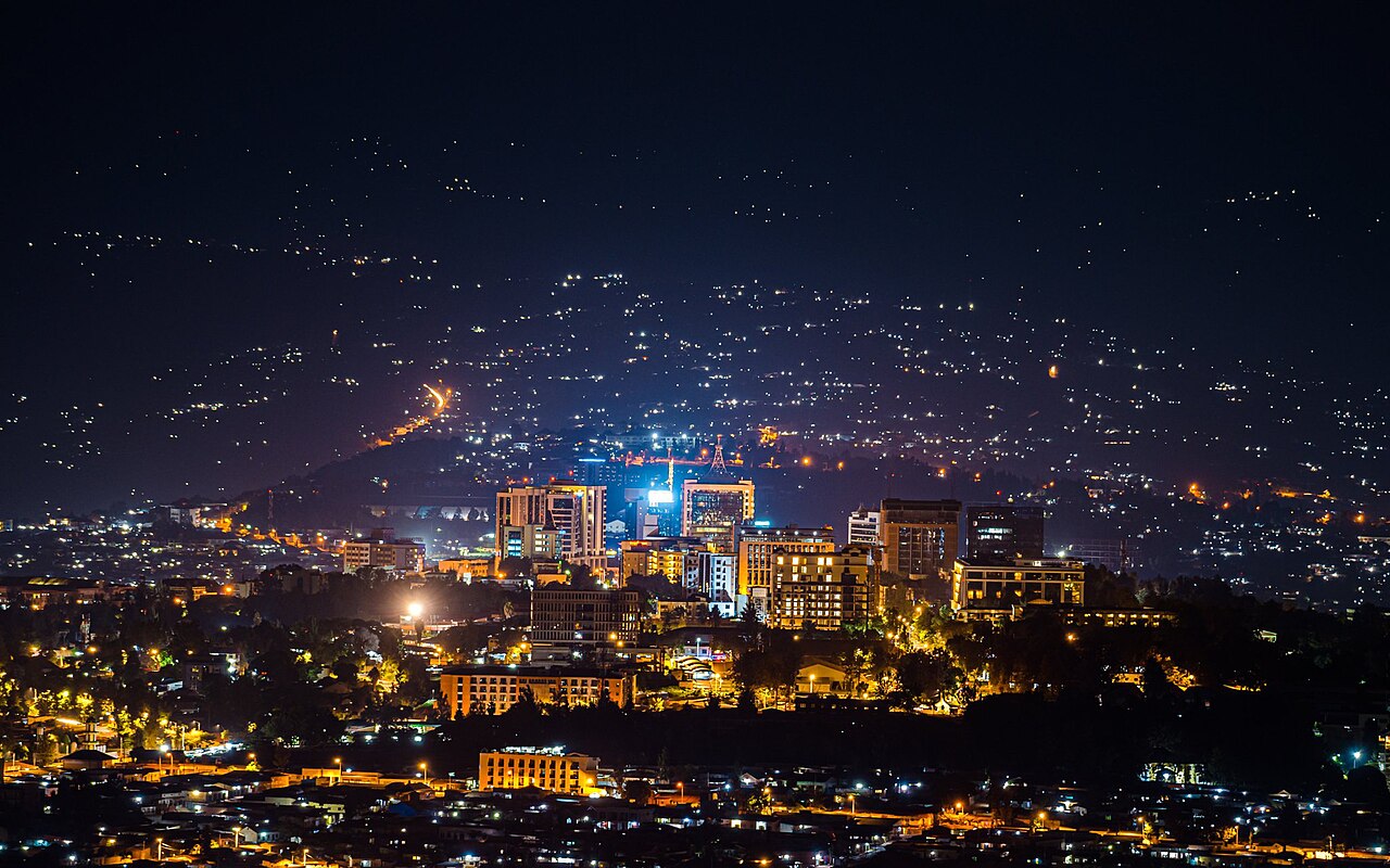 Kigali lit up across its hills at night.